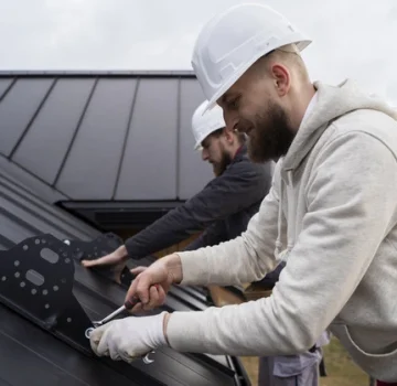 Commercial roof with snow and ice buildup requiring repair services